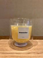 A double-walled glass candle with a wooden lid and a label that reads 'Serenity', featuring a clear wax candle inside.