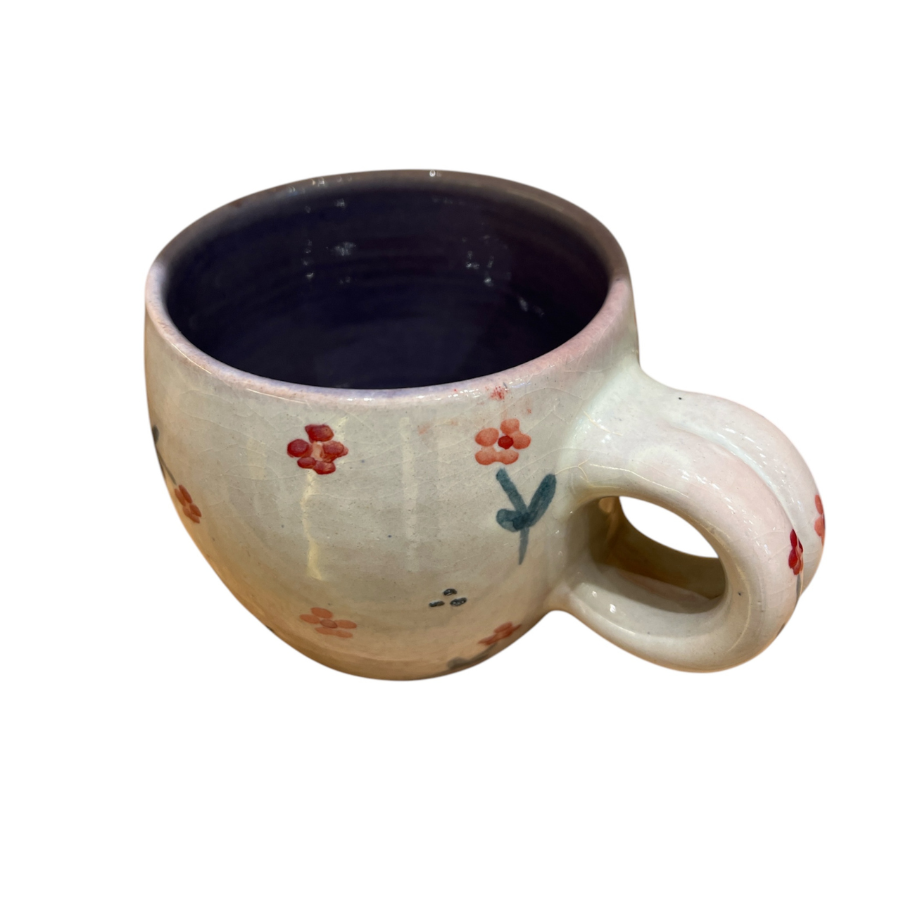 Ceramic mug with floral designs on a white background