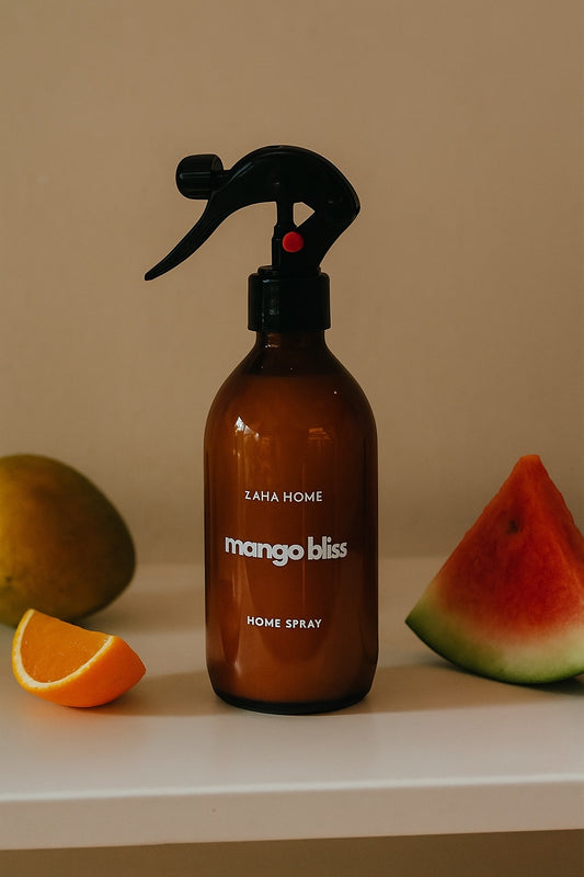 Brown spray bottle labeled 'mango bliss' with fruits on a beige background