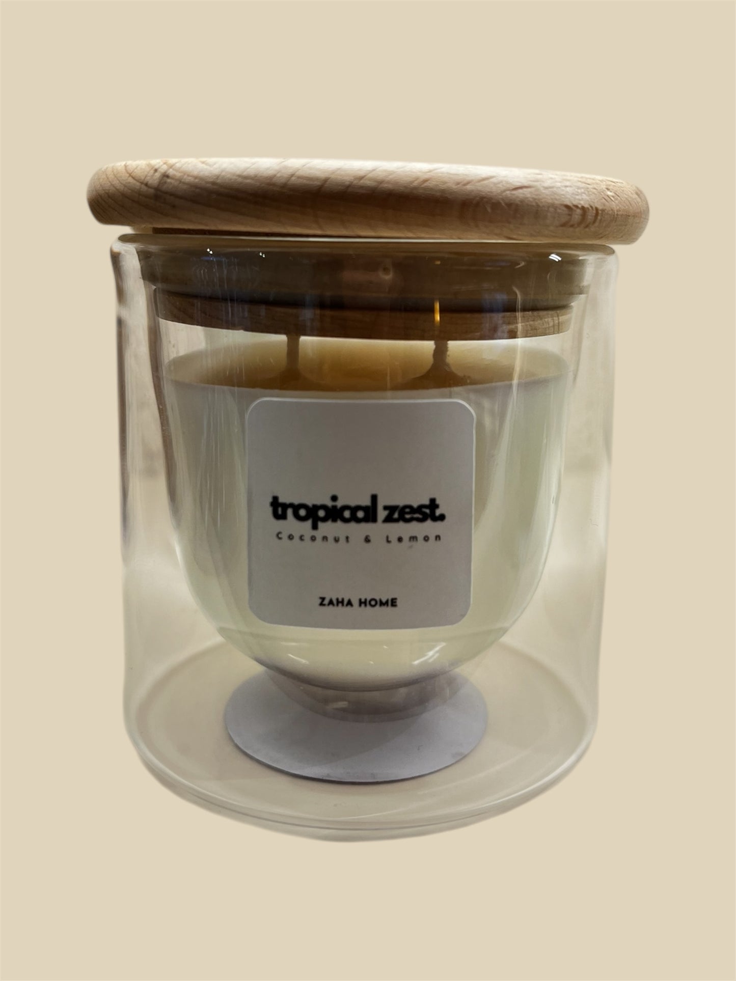 A double-walled glass candle with a wooden lid and a label that reads 'Serenity', featuring a clear wax candle inside.