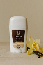 Vanilla-scented deodorant stick with a vanilla flower on a beige background
