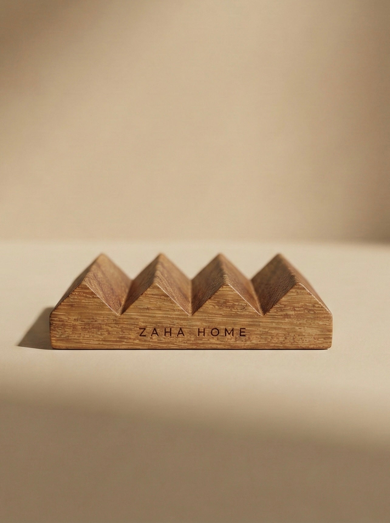 Wooden soap dish with 'Zaha Home' branding on a beige background