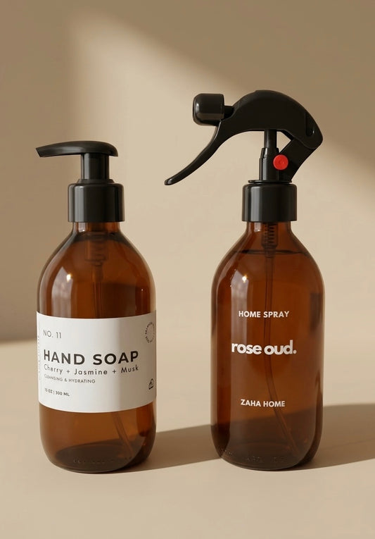 Two Zaha Home bottles, one for hand soap and the other for home spray, on a beige background.