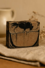 Bar of soap with a marbled design on a textured surface
