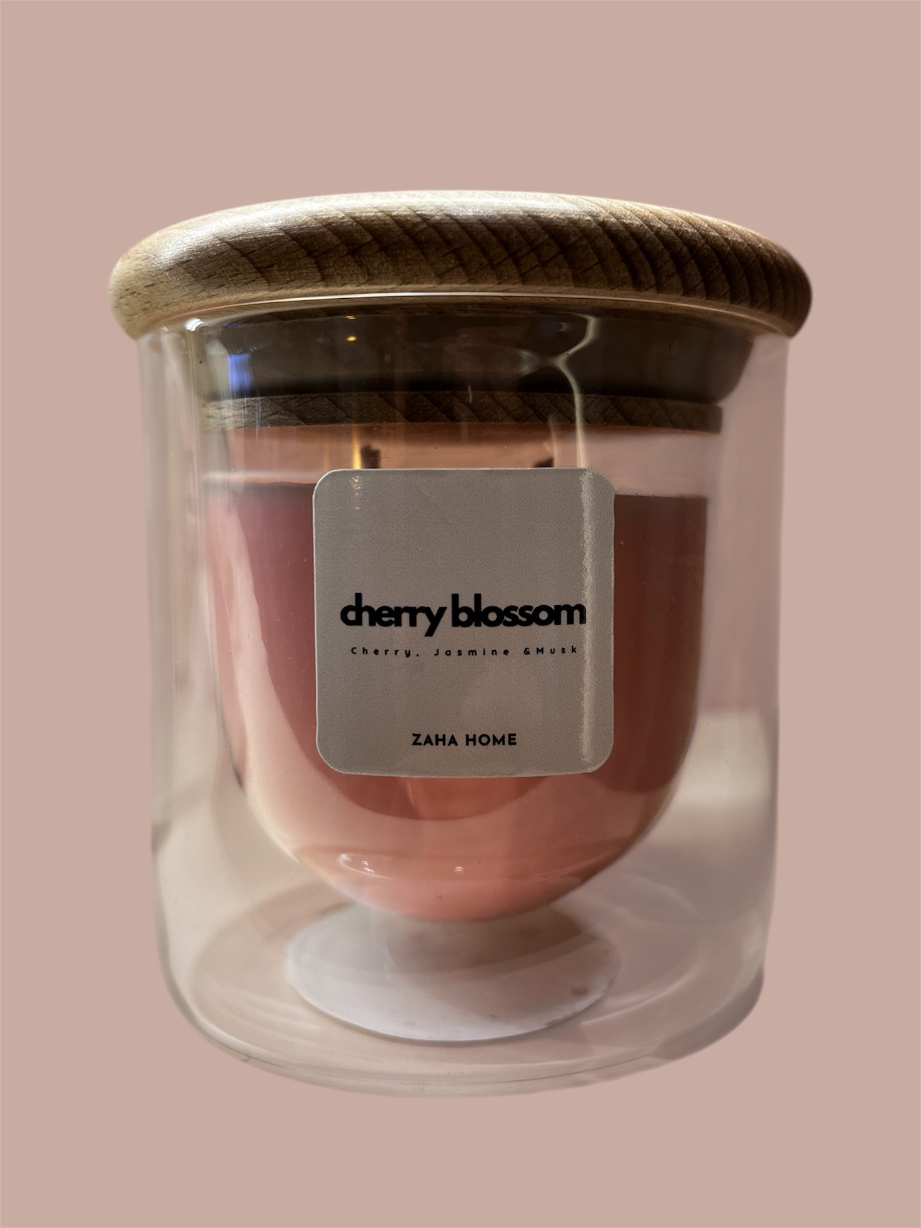 A double-walled glass candle with a wooden lid and a label that reads 'Serenity', featuring a clear wax candle inside.