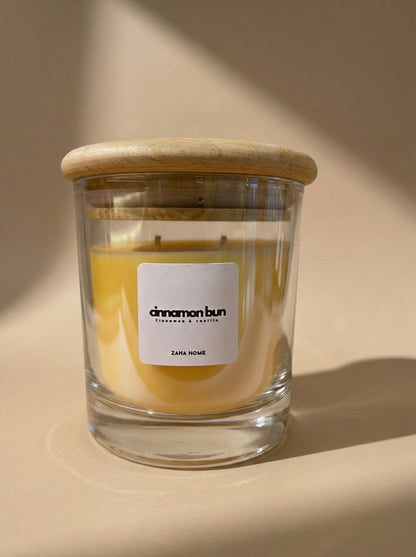 Glass candle with wooden lid on a beige background