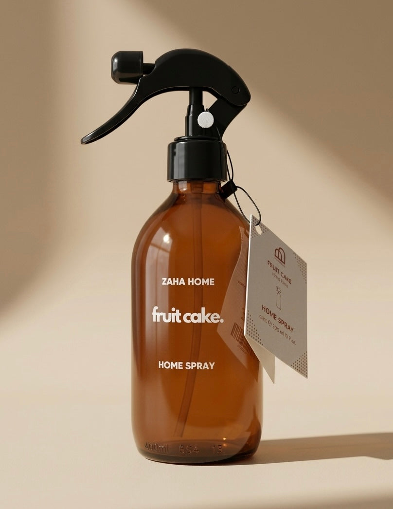 Brown spray bottle labeled 'fruit cake' with a tag on a beige background