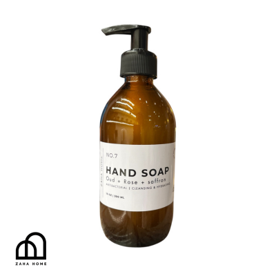 Brown bottle of hand soap with a label on a white background