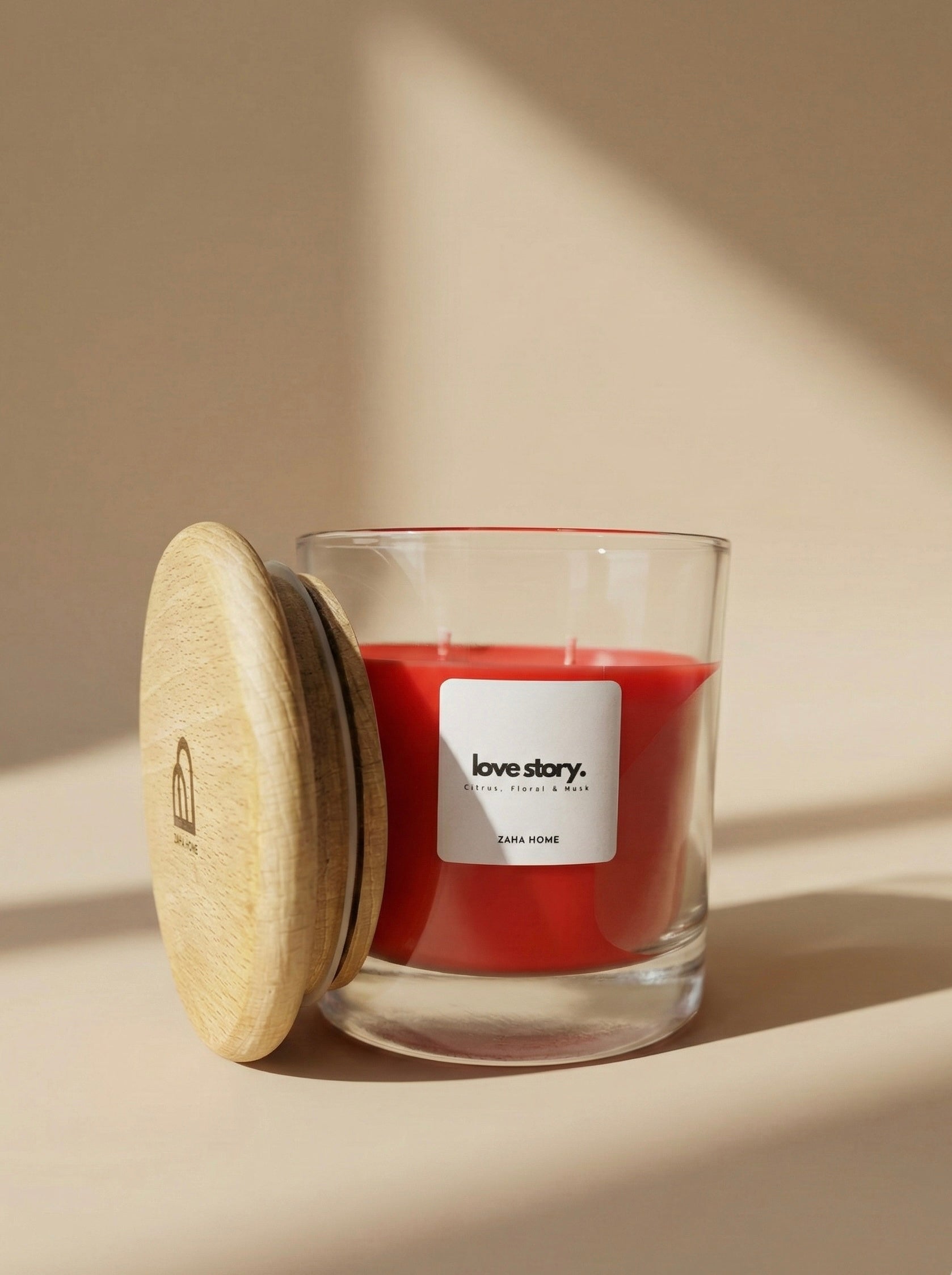 Red candle in a glass jar with a wooden lid on a beige background