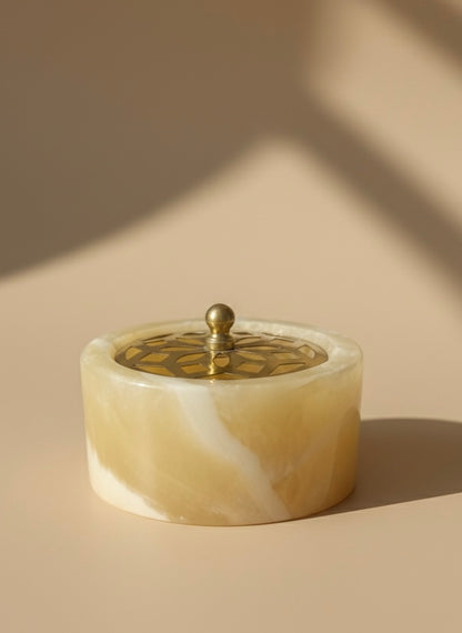 Decorative container (Mabkhara) with a lid on a beige background