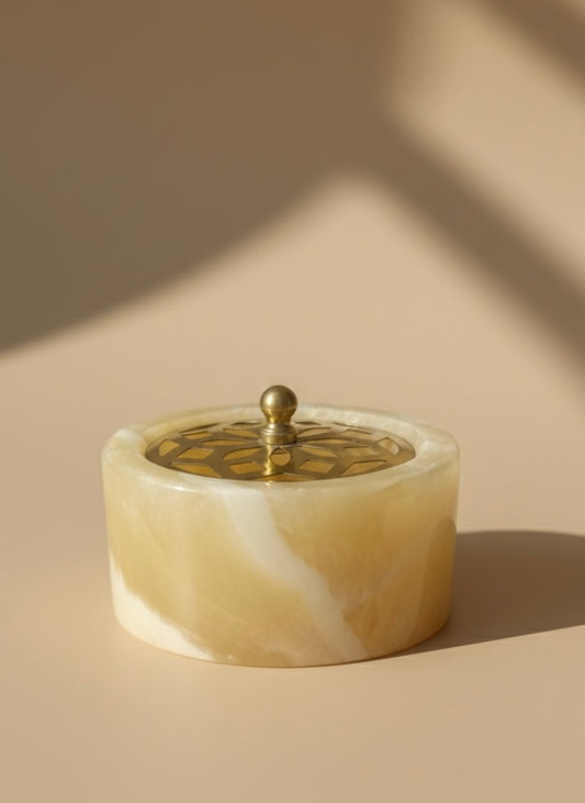 Decorative container (Mabkhara) with a lid on a beige background