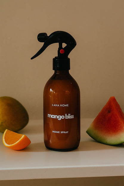 Brown spray bottle labeled 'mango bliss' with fruits on a beige background
