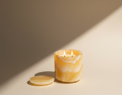 Marbled candle with wooden lid on a beige background