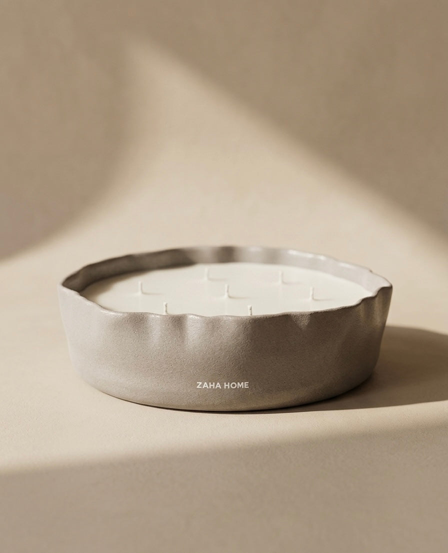 Scented candles in a decorative bowl with a textured surface on a beige background, featuring the brand 'Zaha Home'.
