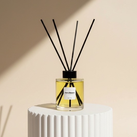 Reed diffuser on a white pedestal with a beige background