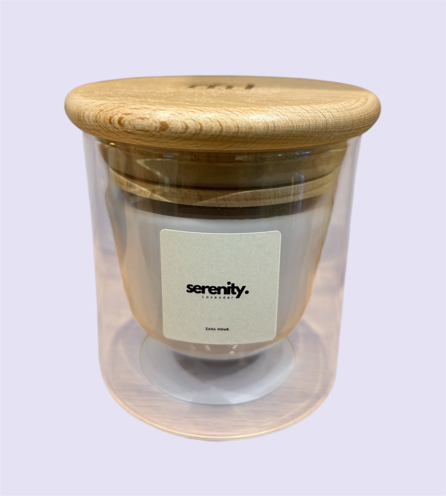 A double-walled glass candle with a wooden lid and a label that reads 'Serenity', featuring a clear wax candle inside.