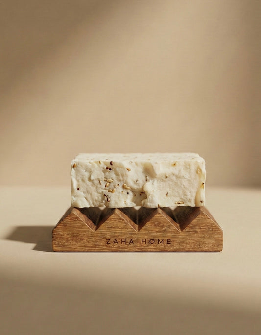 Soap bar on a wooden soap dish with 'Zaha Home' branding against a beige background