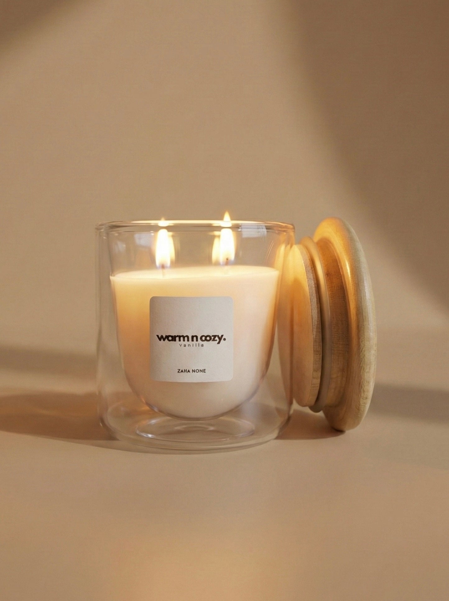 Candle in a glass jar with a wooden lid on a beige background