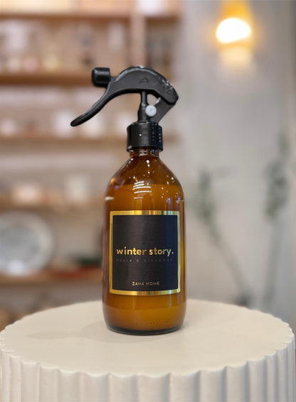 Brown spray bottle with label on a white surface with a blurred background.