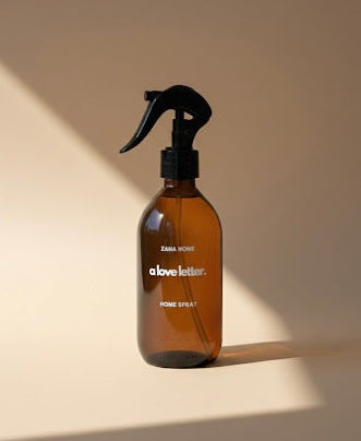 Brown spray bottle with black nozzle on a beige background